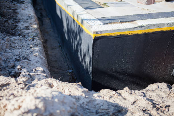 Professional Waterproofing technician working in Livonia, NY